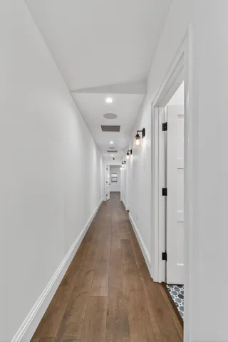 a bedroom with a bed a chandelier and table
