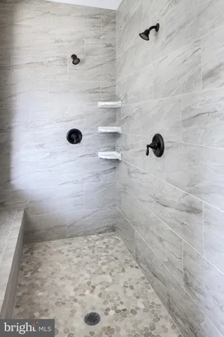 a white bath tub sitting in a bathroom