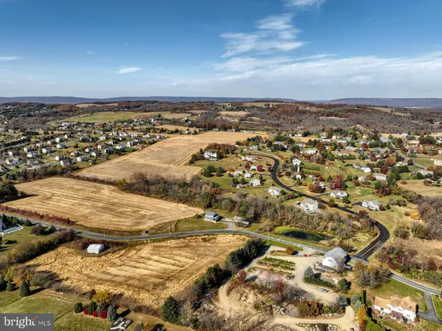 an aerial view of residential building with yard
