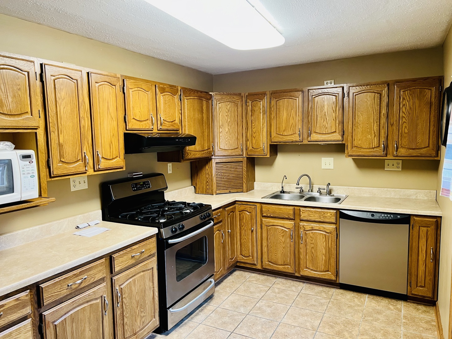 316 Erickson Road Rochelle, IL 61068 - Photo 2 of 17 a kitchen with stainless steel appliances granite countertop a stove a sink dishwasher and a microwave oven with cabinets