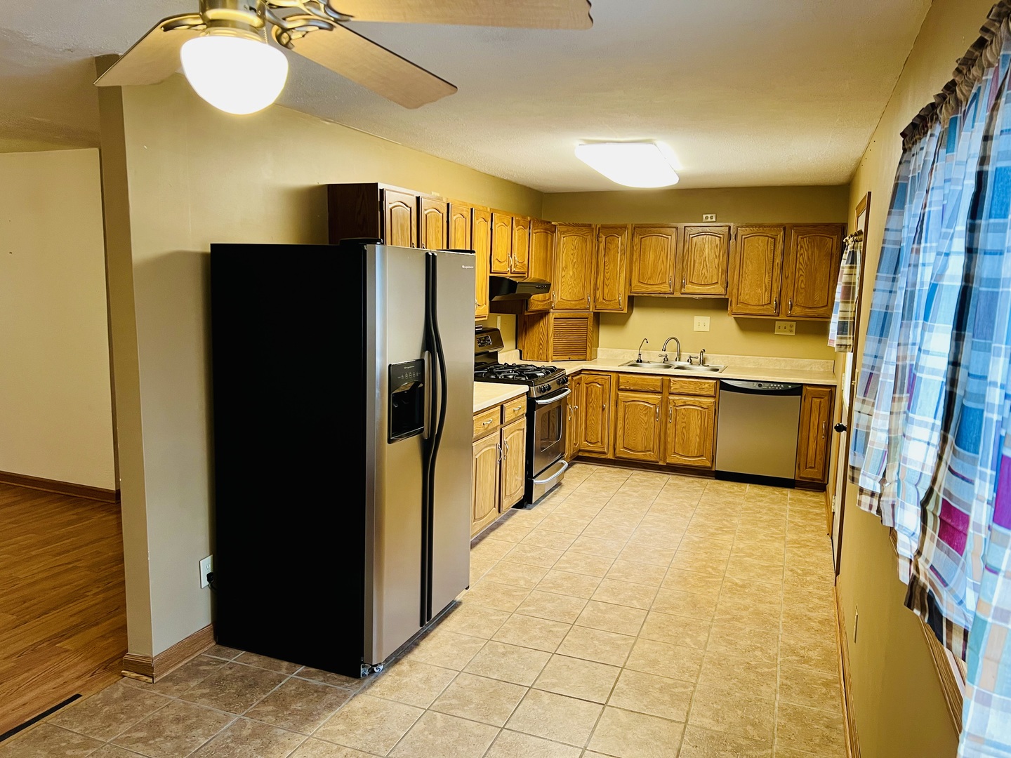316 Erickson Road Rochelle, IL 61068 - Photo 3 of 17 a kitchen with stainless steel appliances a refrigerator and a stove