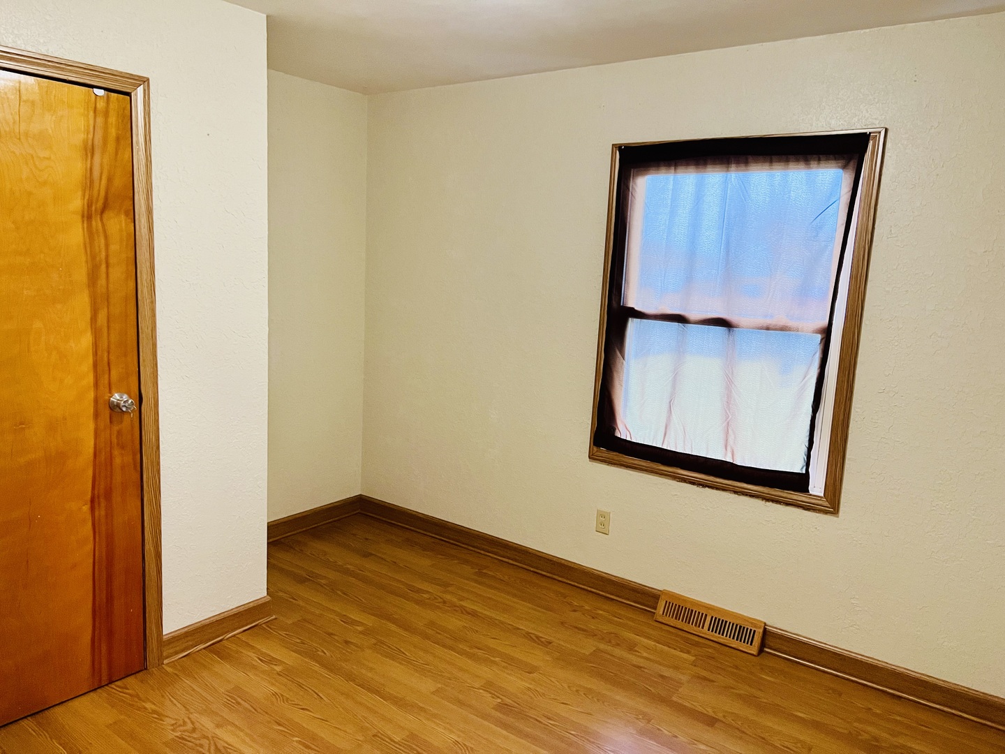 316 Erickson Road Rochelle, IL 61068 - Photo 6 of 17 a view of an empty room with wooden floor and a window