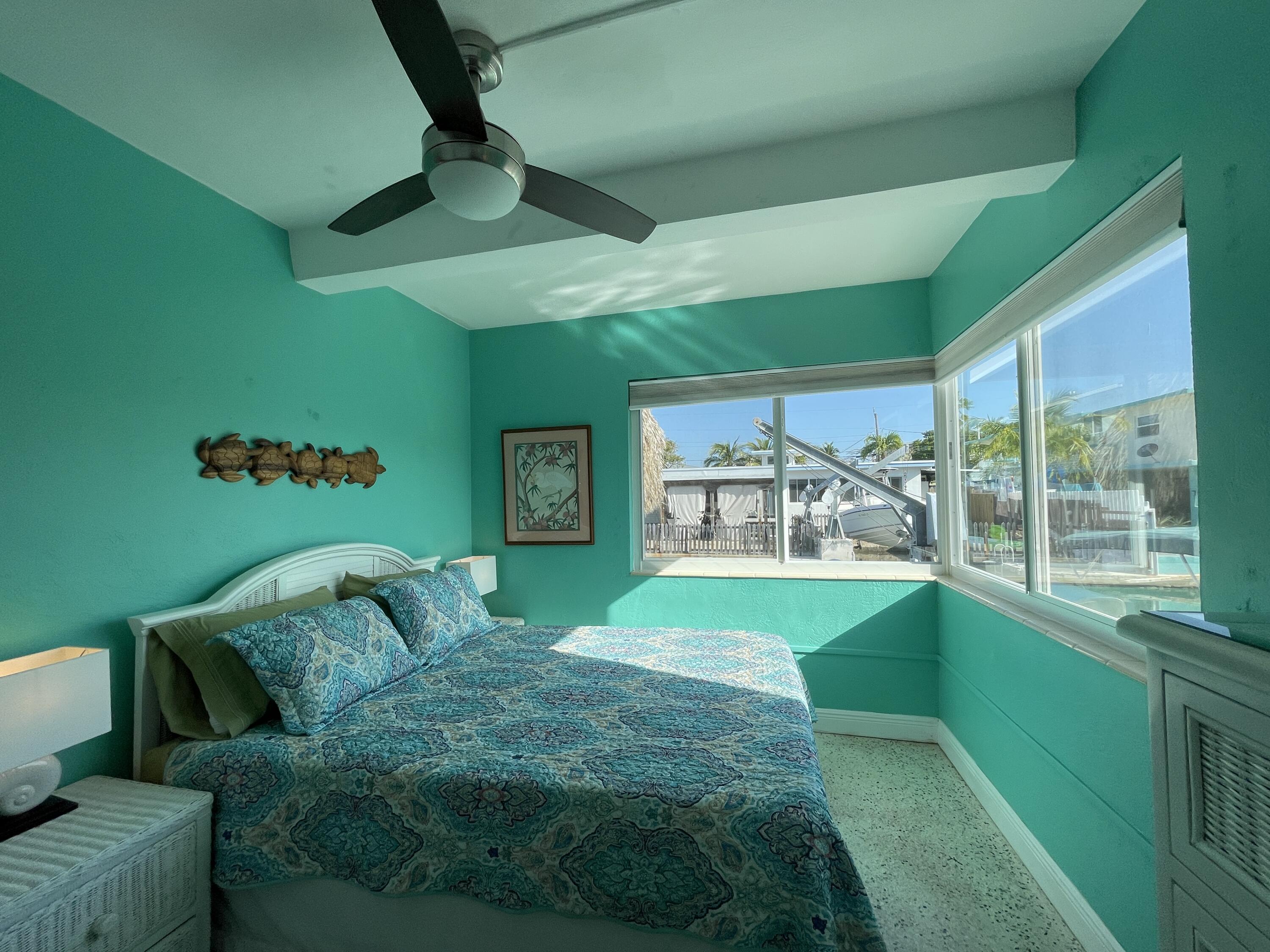 64 Seagate Boulevard Key Largo, FL 33037 - Photo 16 of 44 a bedroom with a bed and a window