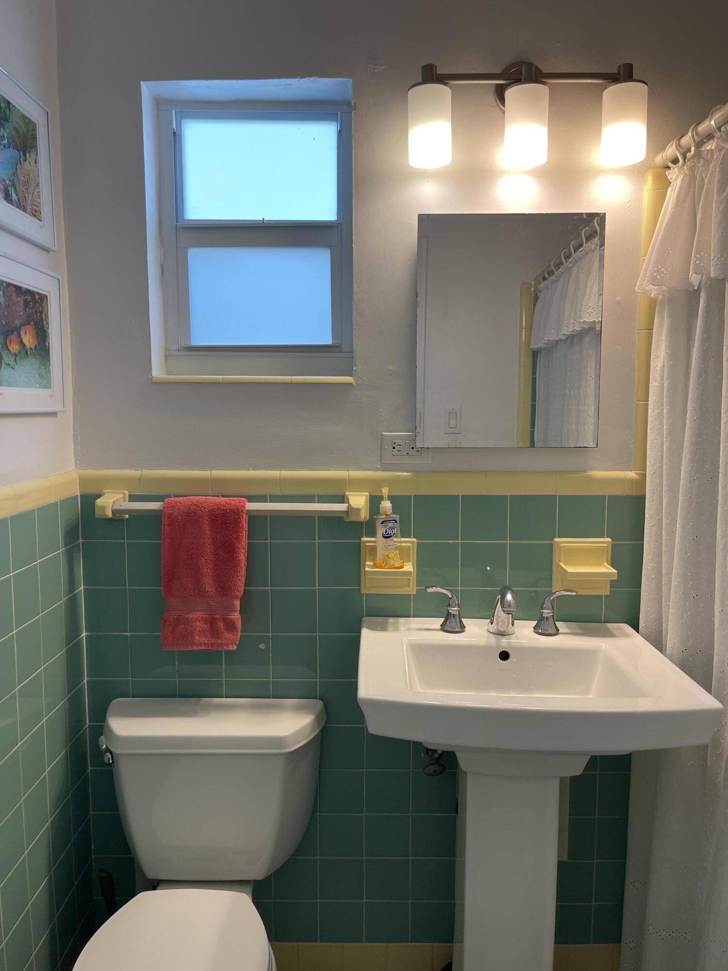 64 Seagate Boulevard Key Largo, FL 33037 - Photo 20 of 44 a bathroom with a toilet sink and mirror