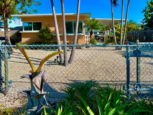 a front view of house with yard outdoor seating and barbeque oven