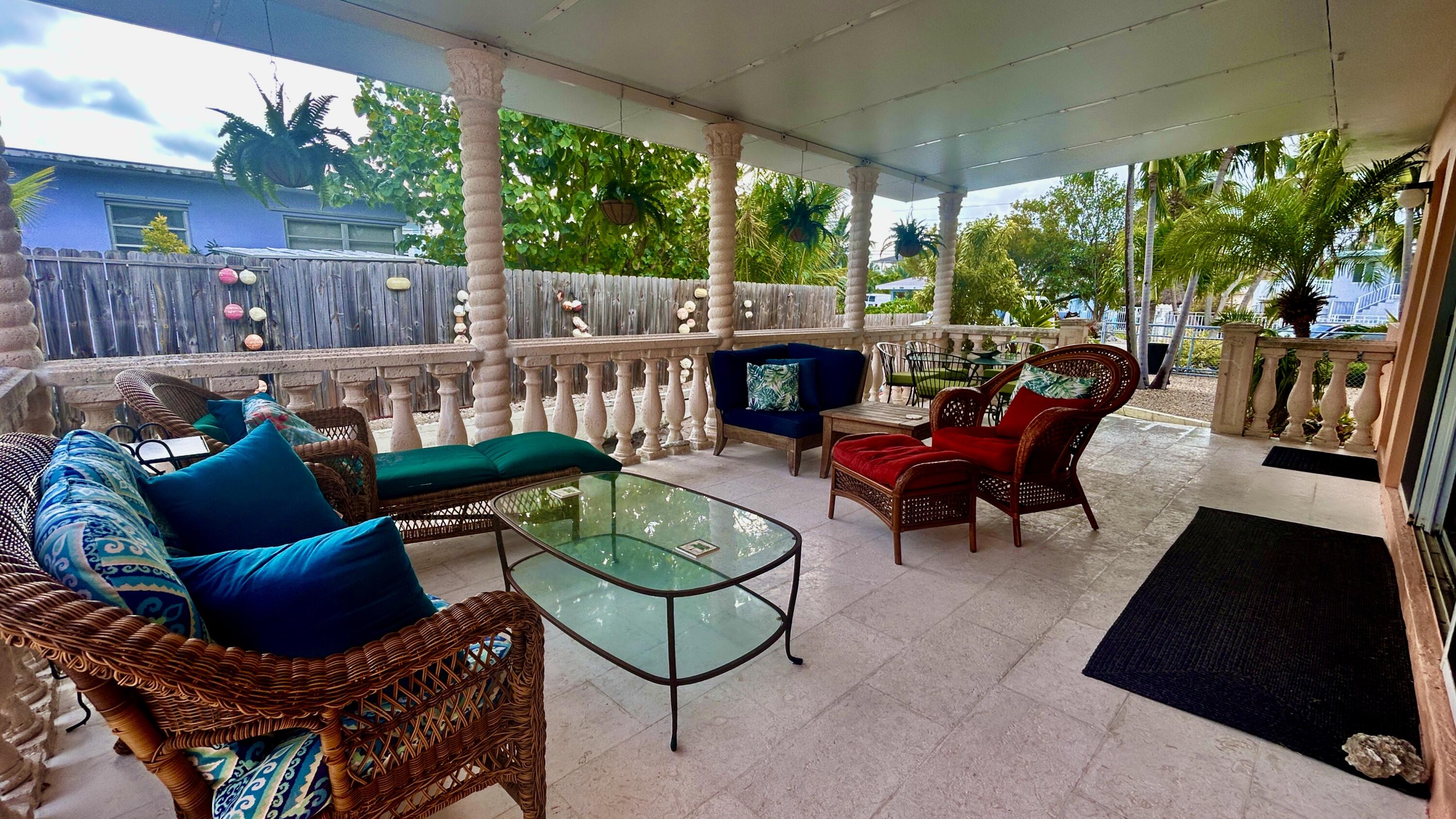 64 Seagate Boulevard Key Largo, FL 33037 - Photo 36 of 44 a backyard of a house with outdoor seating