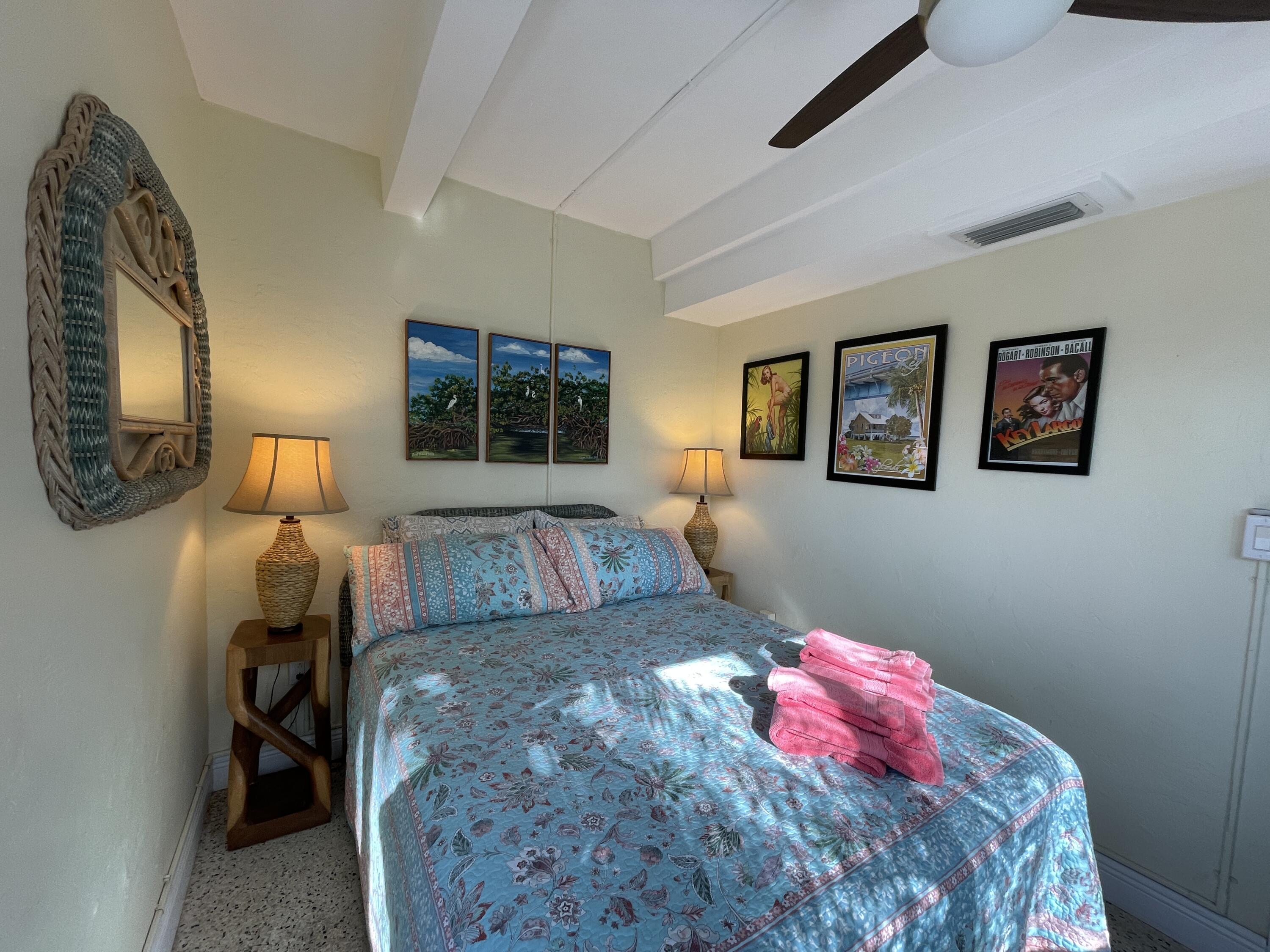 64 Seagate Boulevard Key Largo, FL 33037 - Photo 44 of 44 a bedroom with a bed and wooden floor