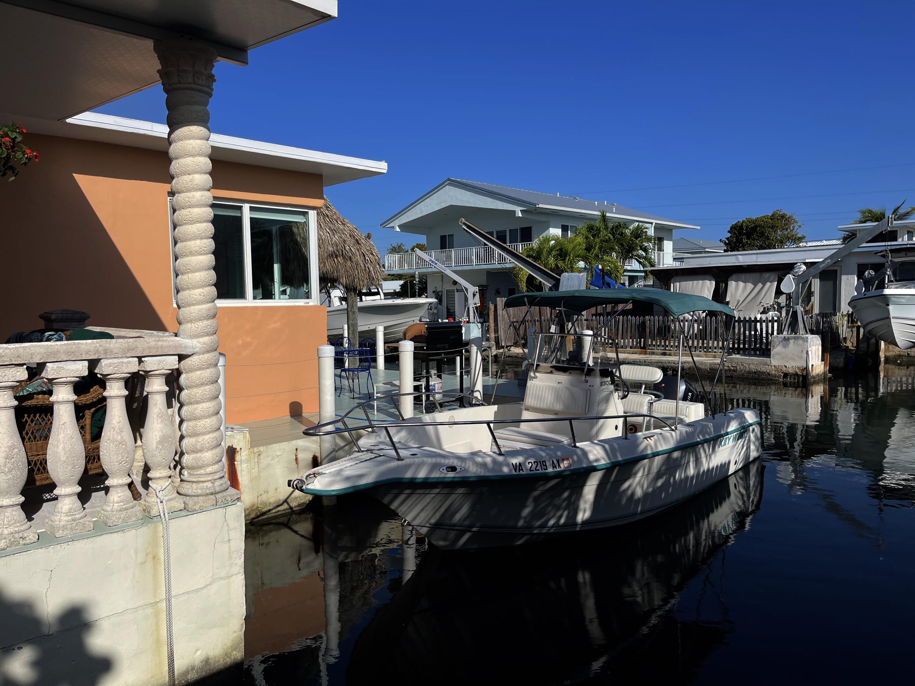 64 Seagate Boulevard Key Largo, FL 33037 - Photo 7 of 44 a view of a dinning tables and chairs in patio