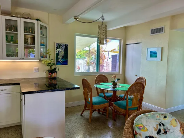 a view of a very nice looking dining room with furniture