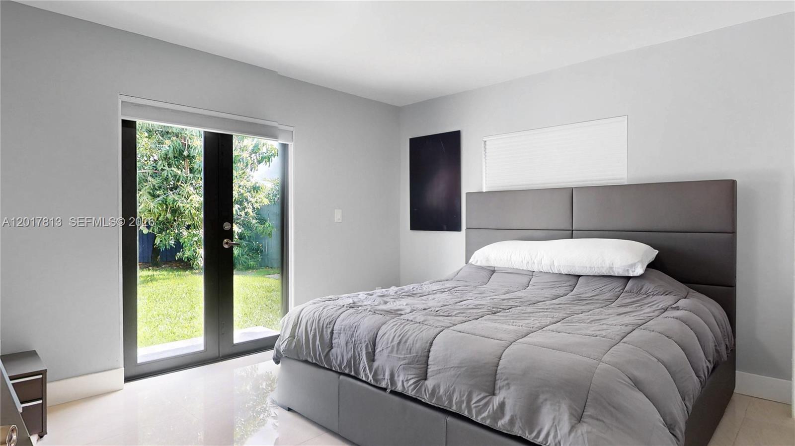 12535 Southwest 31st Terrace Miami, FL 33175 - Photo 14 of 32 a bedroom with a large bed and a window