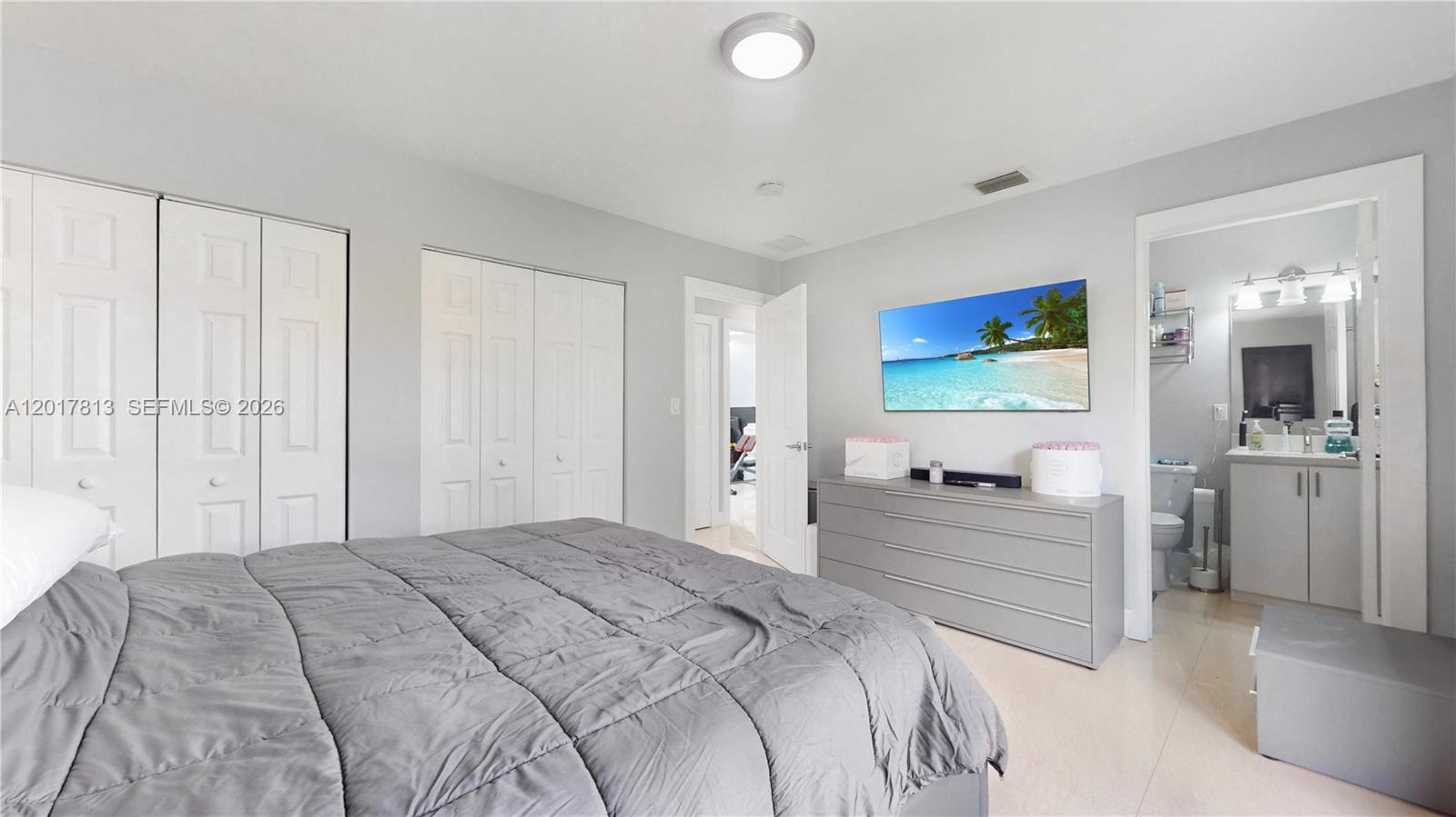 12535 Southwest 31st Terrace Miami, FL 33175 - Photo 15 of 32 a bedroom with a bed and a flat screen tv