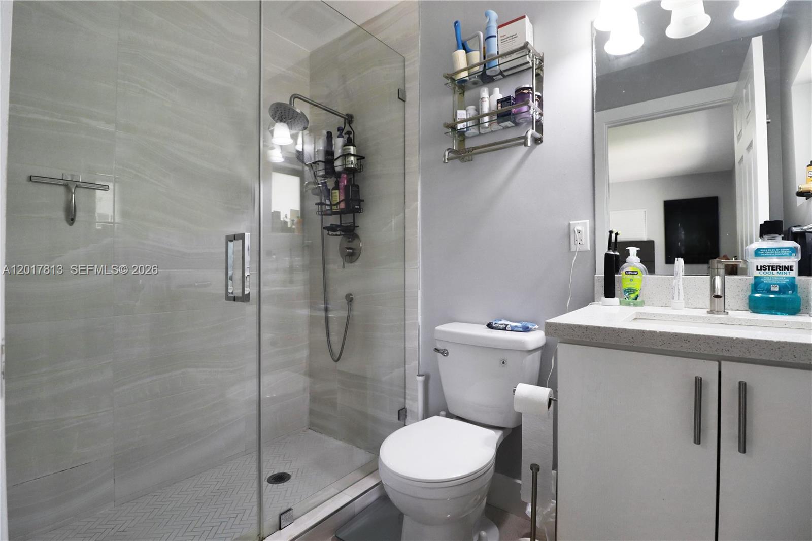 12535 Southwest 31st Terrace Miami, FL 33175 - Photo 16 of 32 a bathroom with a granite countertop sink toilet and shower