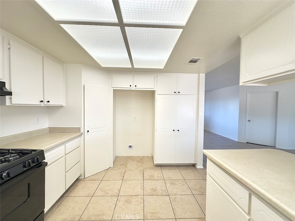 22311 Thunderbird Road Apple Valley, CA 92307 - Photo 11 of 18 a kitchen with a stove cabinets and a refrigerator