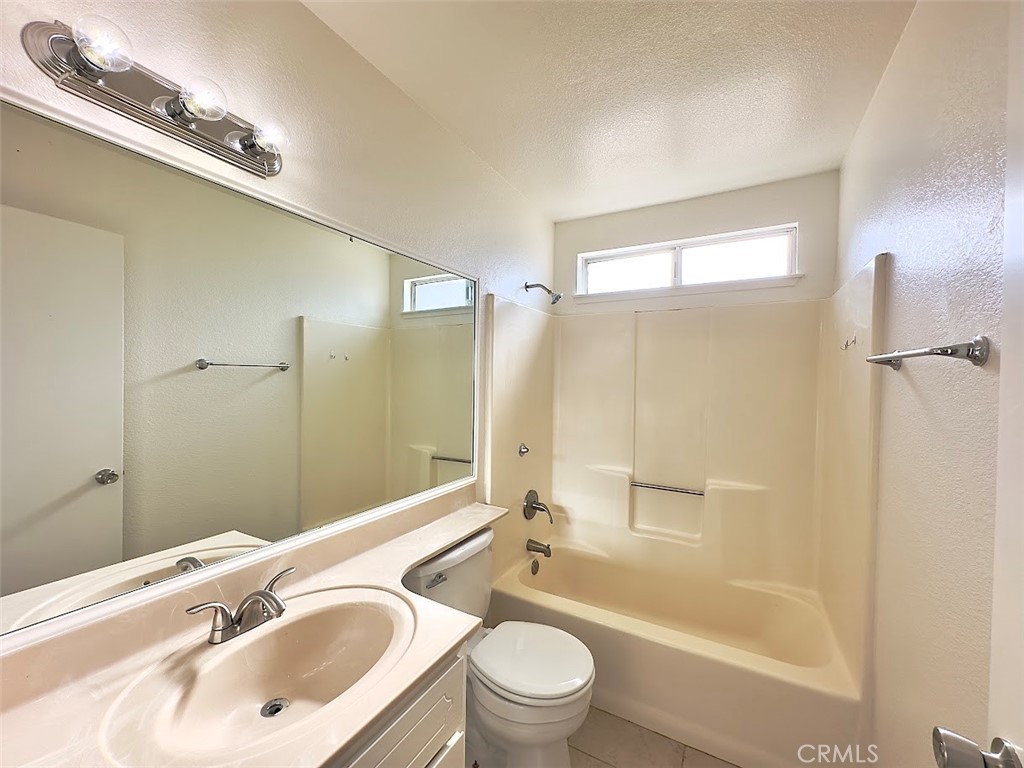 22311 Thunderbird Road Apple Valley, CA 92307 - Photo 17 of 18 a bathroom with a bathtub shower sink vanity mirror and toilet
