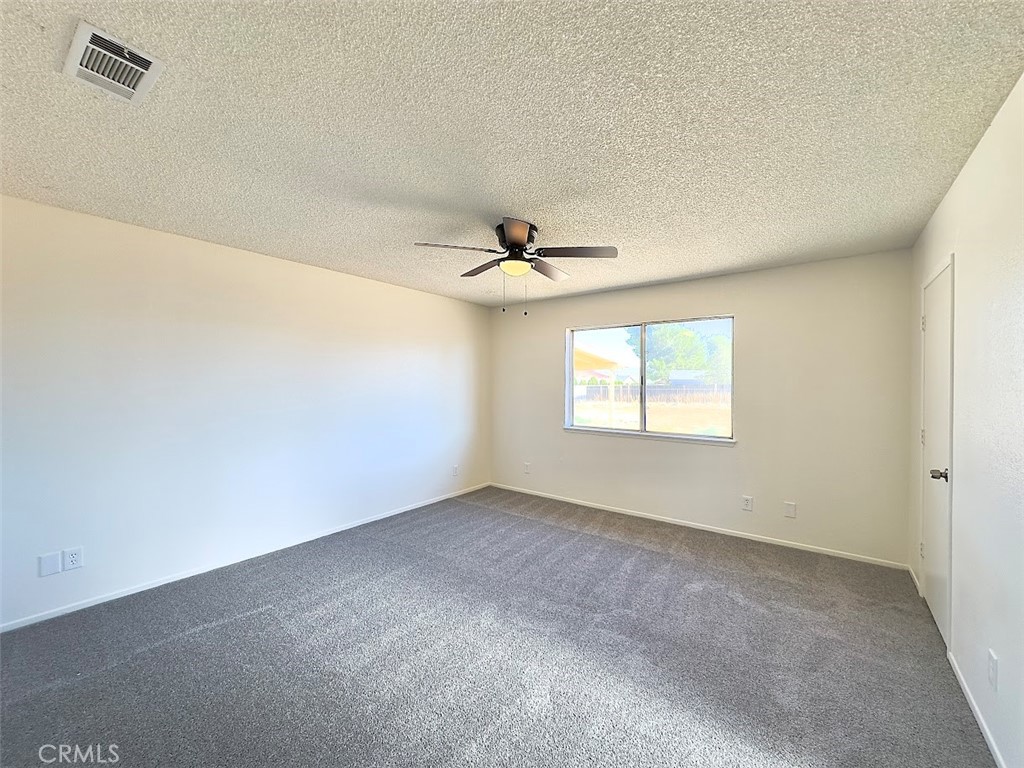 22311 Thunderbird Road Apple Valley, CA 92307 - Photo 18 of 18 an empty room with a window