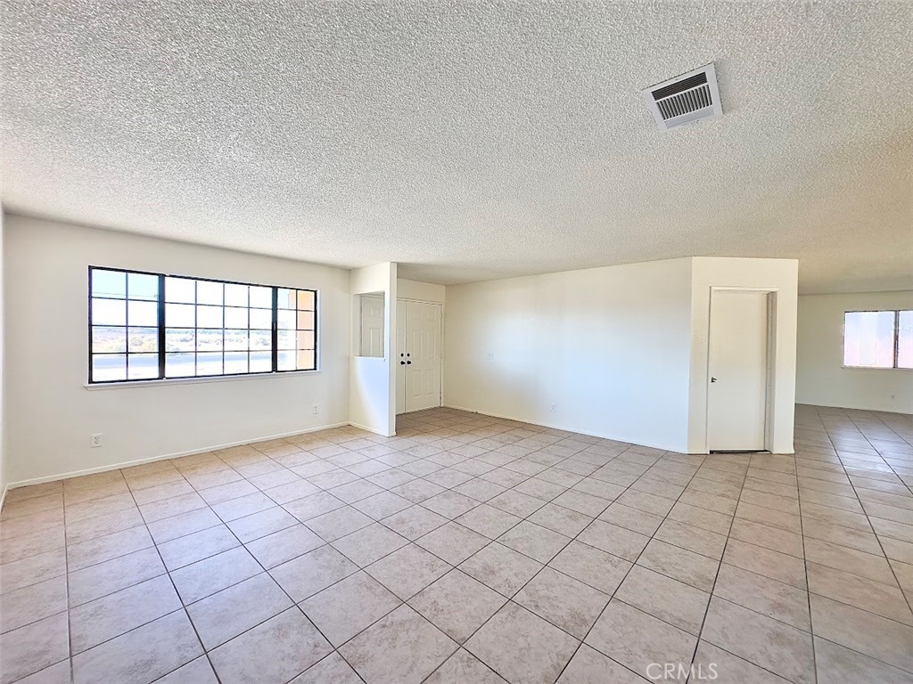 22311 Thunderbird Road Apple Valley, CA 92307 - Photo 3 of 18 an empty room with windows