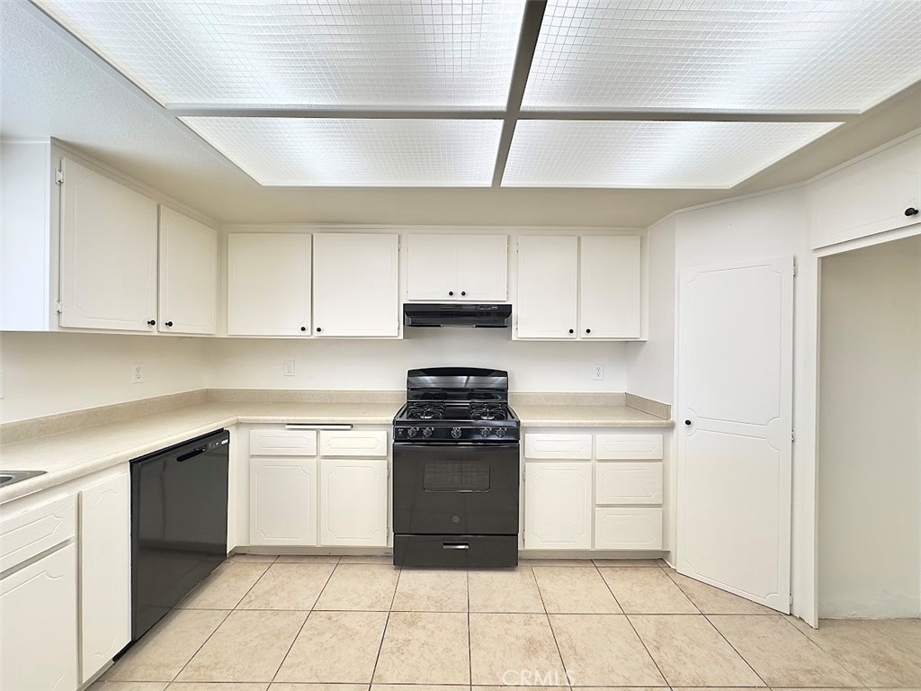 22311 Thunderbird Road Apple Valley, CA 92307 - Photo 8 of 18 a kitchen with a stove top oven and cabinets