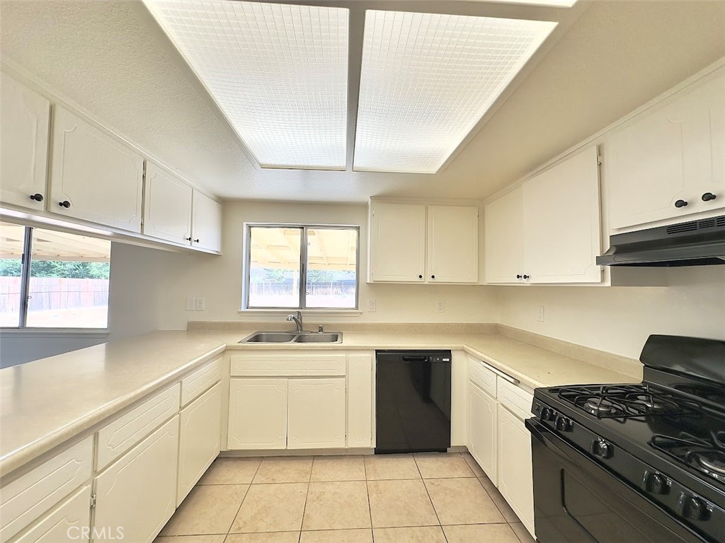 22311 Thunderbird Road Apple Valley, CA 92307 - Photo 9 of 18 a kitchen with a sink stove top oven and cabinets
