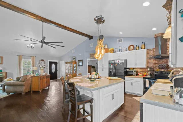 a kitchen with lots of counter top space and wooden floor