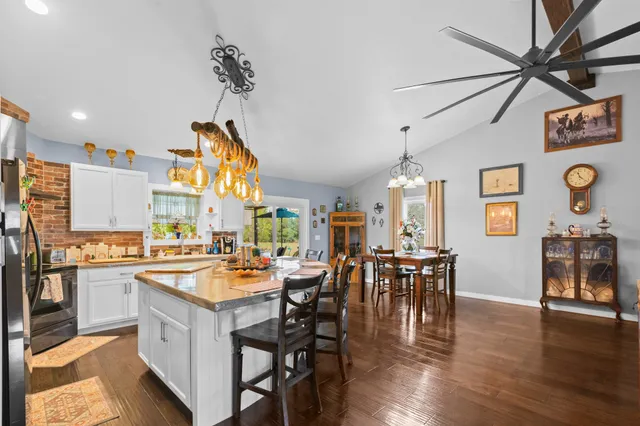 a kitchen with a sink stove top oven and cabinets