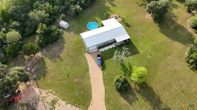 an aerial view of a house with a yard