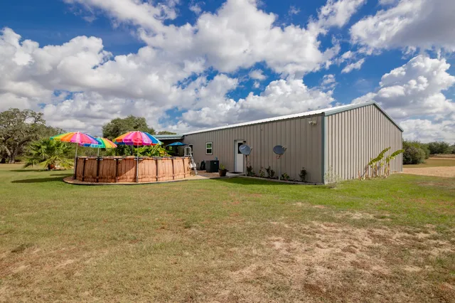 a view of a yard with table and chairs
