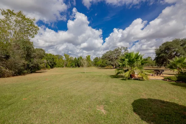a view of a house with a yard and garage