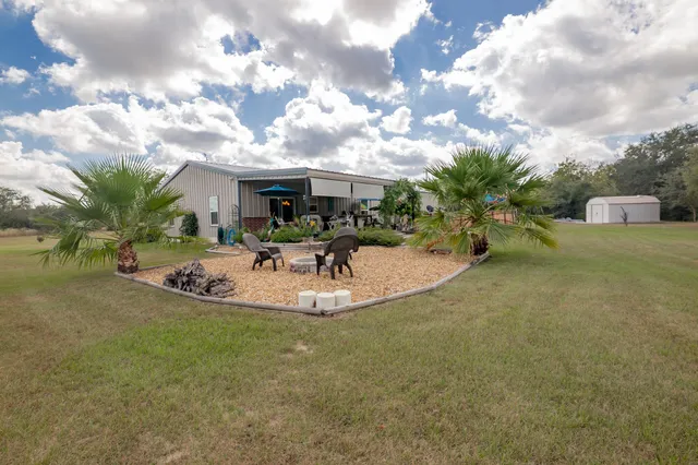a view of a field with trees in background