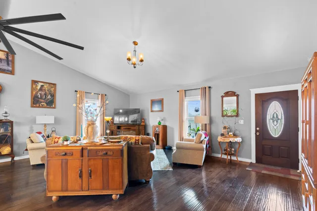 a living room with furniture wooden floor and window