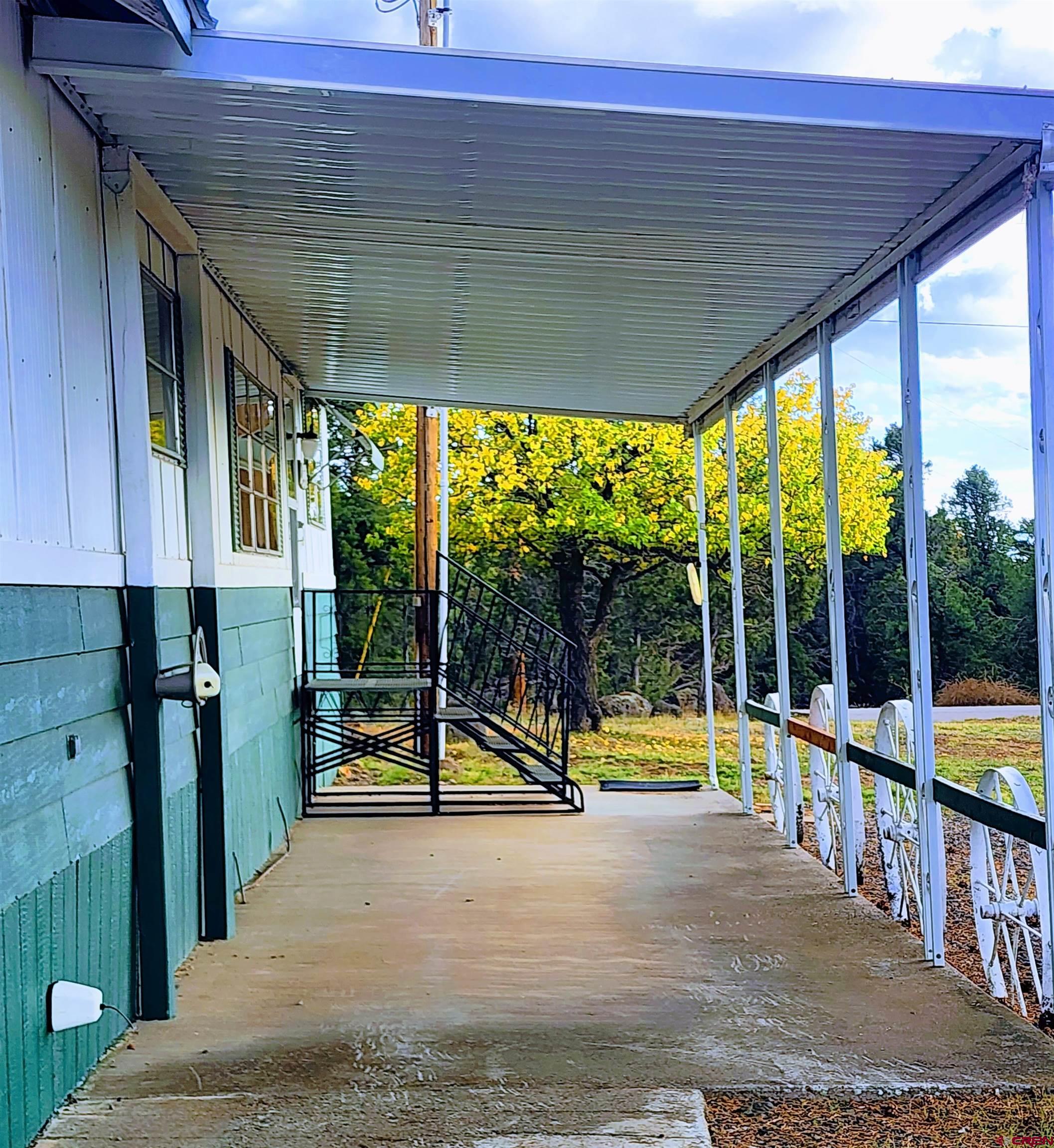 24593 Timothy Road Cedaredge, CO 81413 - Photo 11 of 33 a view of a swimming pool with a porch