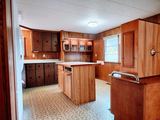 a kitchen with stainless steel appliances granite countertop a refrigerator a sink and a stove