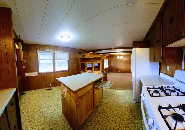 a kitchen with a sink and a large window