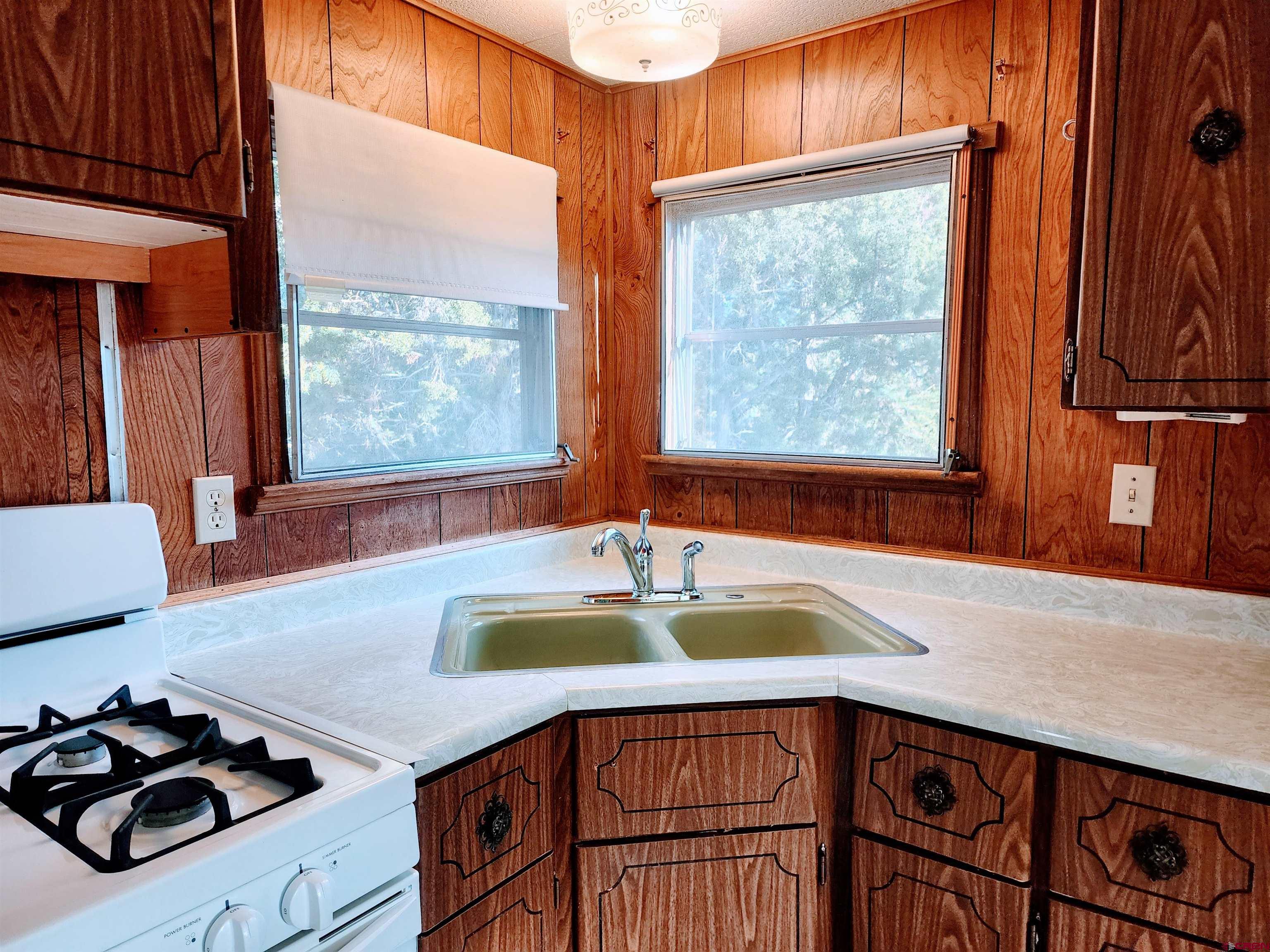 24593 Timothy Road Cedaredge, CO 81413 - Photo 25 of 41 a kitchen with a sink and a large window