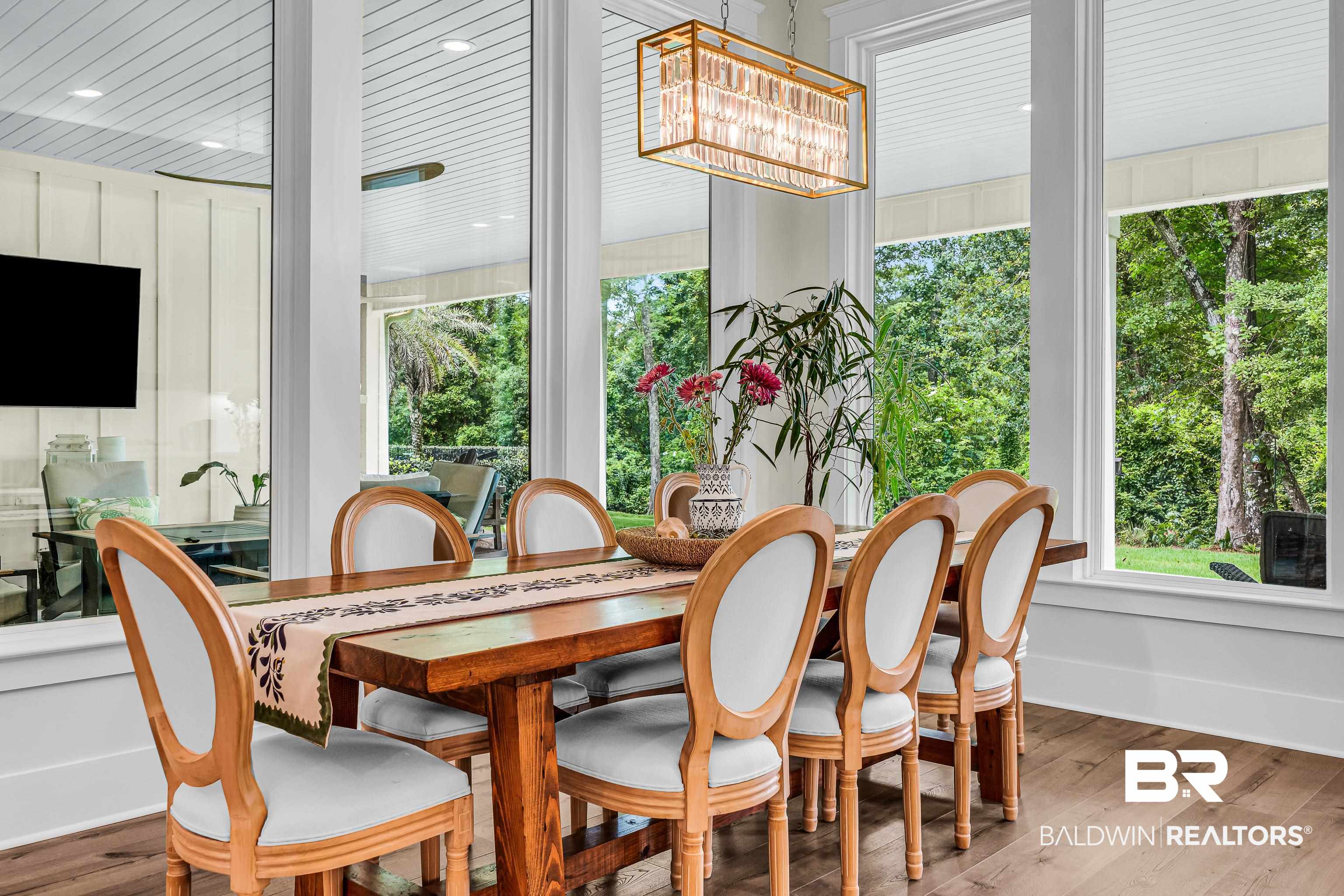 17541 Polo Ridge Boulevard Fairhope, AL 36532 - Photo 10 of 19 Dining area featuring wood-finish flooring, a rectangular wood table, and an ornate rectangular chandelier
