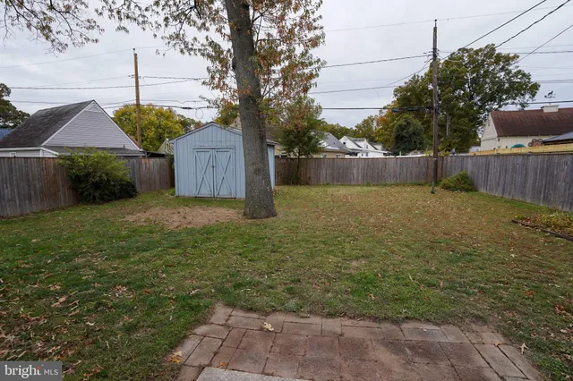 a view of a yard with wooden fence