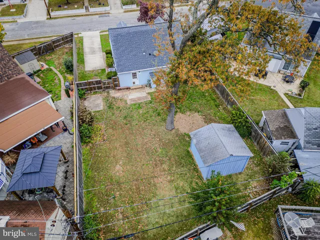 an aerial view of a residential houses with outdoor space and parking