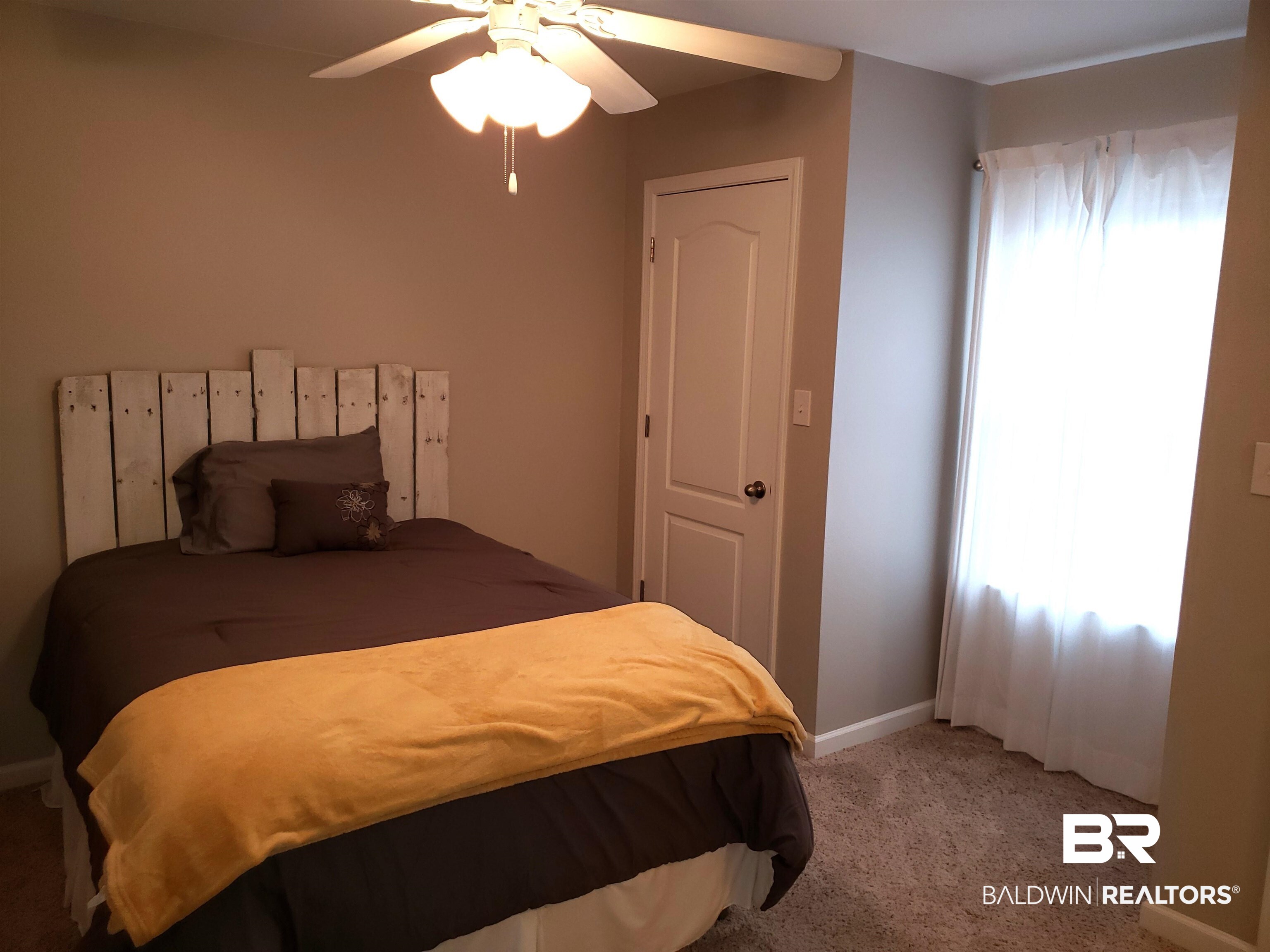 2006 Shelene Way, Unit 2006 Foley, AL 36535 - Photo 12 of 29 Carpeted bedroom featuring ceiling fan and baseboards