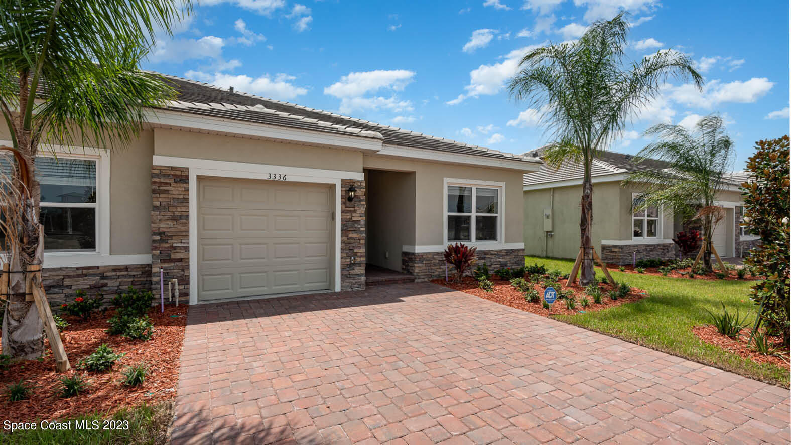 3336 Morrow Place Mims, FL 32754 - Photo 2 of 36 a front view of a house with garden