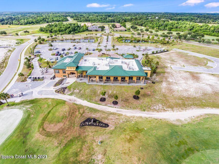 3336 Morrow Place Mims, FL 32754 - Photo 31 of 36 a view of a swimming pool with a lawn chairs under an umbrella