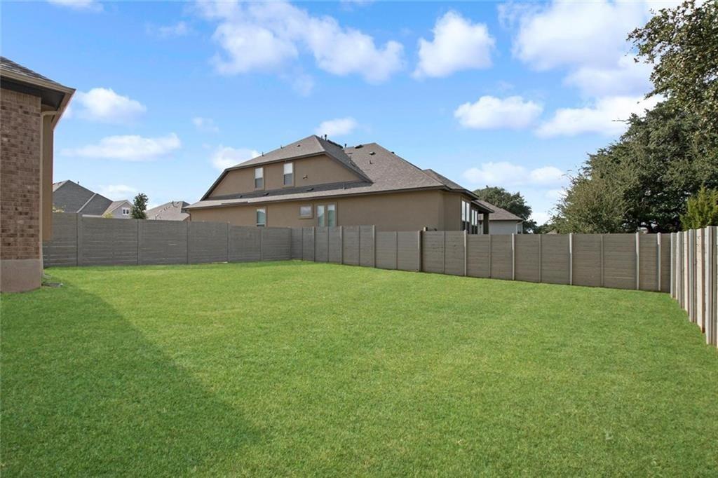 3833 Mercer Road Georgetown, TX 78628 - Photo 24 of 25 A generously sized yard, fully fenced for privacy, provides ample space for outdoor enjoyment.