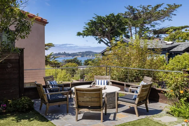 a view of a patio with table and chairs and potted plants