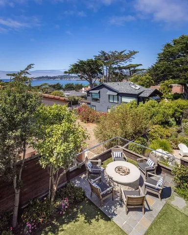 a view of a chairs and table in backyard