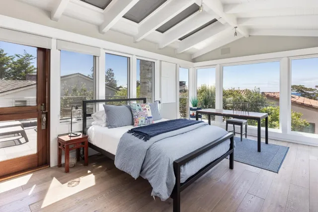 a bed room with a bed and a large window