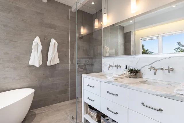 a bathroom with a granite countertop sink a toilet and mirror
