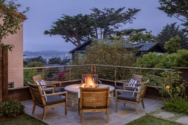 a view of a roof deck with a table and chairs