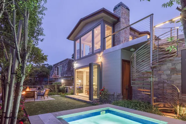 a view of a patio with couches table and chairs and potted plants