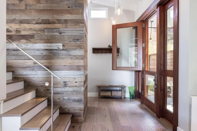 a view of entryway and hall with wooden floor