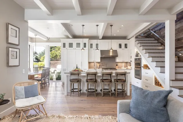 a living room with lots of furniture and a large window