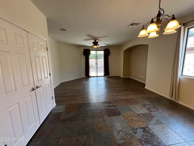 an empty room with closet and windows