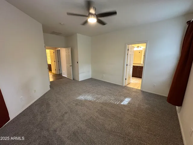 a bathroom with a tub double sink window and mirror